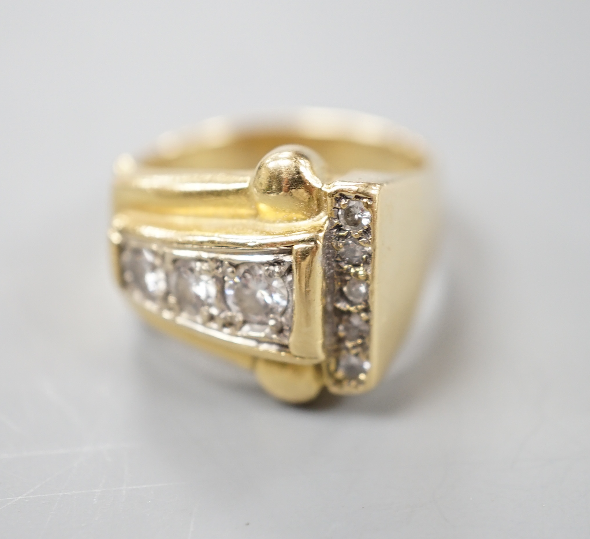 A 1950's yellow metal and graduated eight stone diamond set dress ring, size P/Q, gross 10 grams.